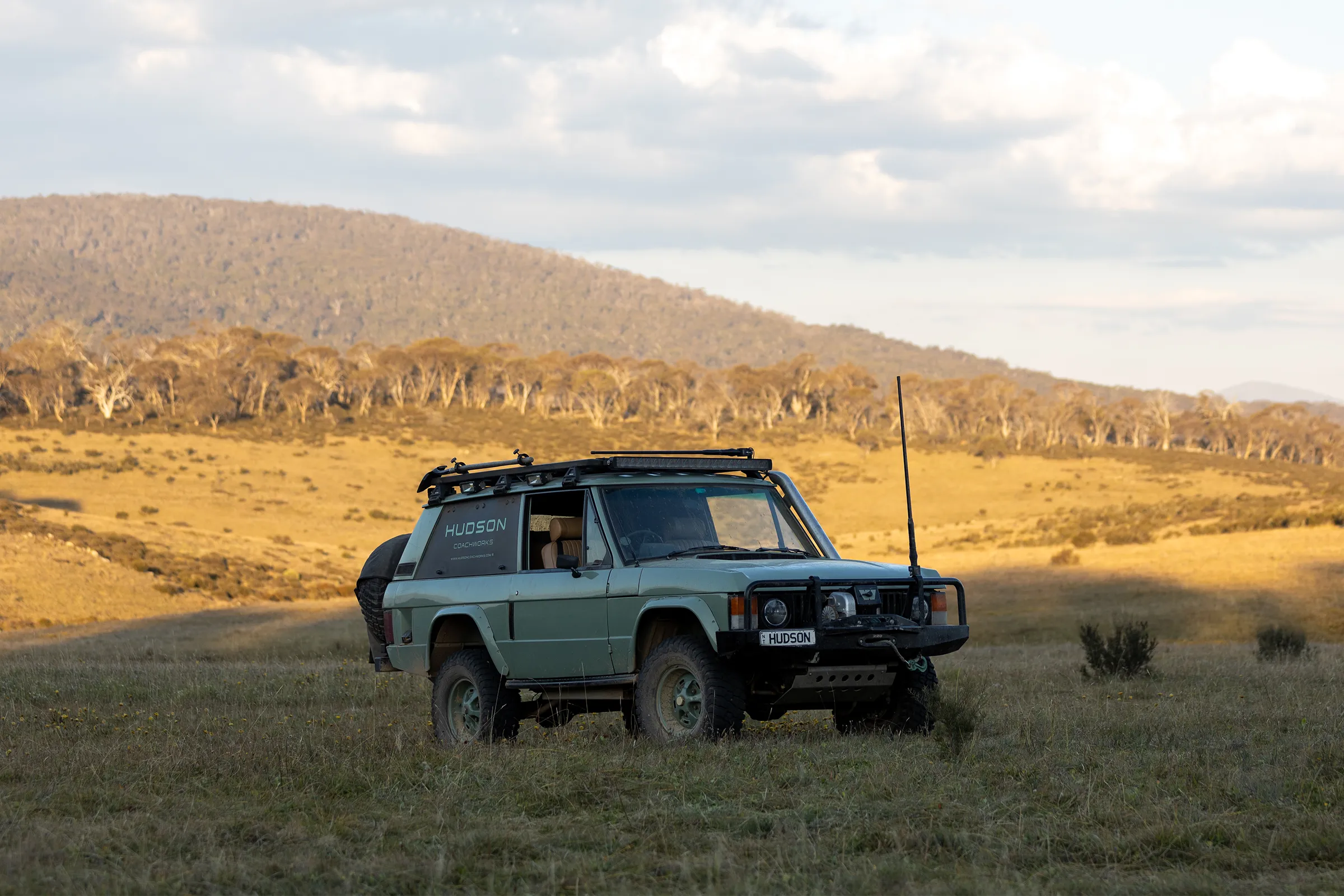 Range Rover Classic in field with rolling hills | Hudson Coachworks Range Rover Expedition | Range Rovers Remastered | Range Rover Classic Restoration