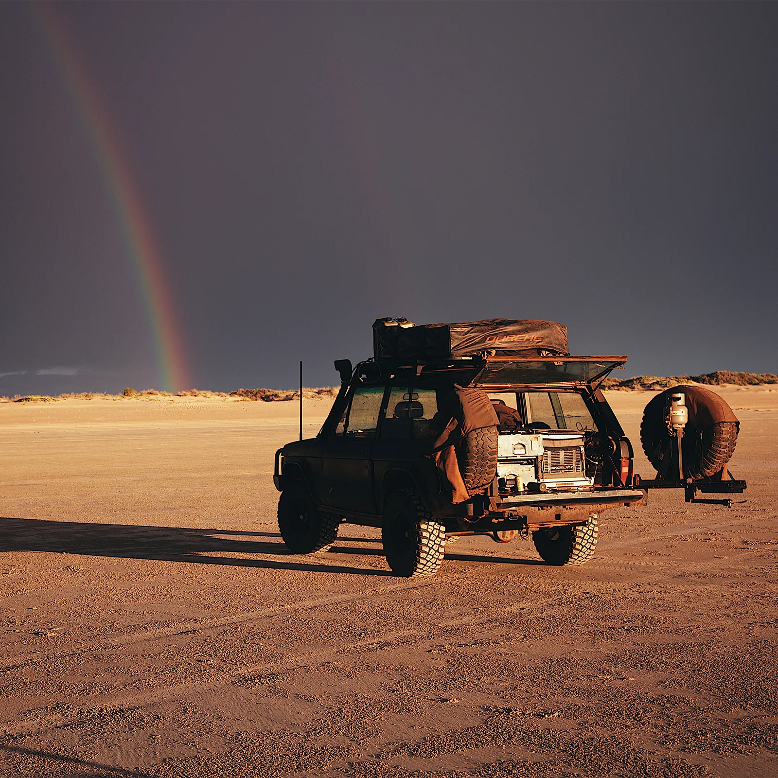 Range Rover Classic on beach at golden hour with rainbow in the background | Range Rover Adventures | Range Rover Classic | Range Rover Restoration | Range Rove Build | Overlanding Range Rover Classic | Touring Range Rover Classsic