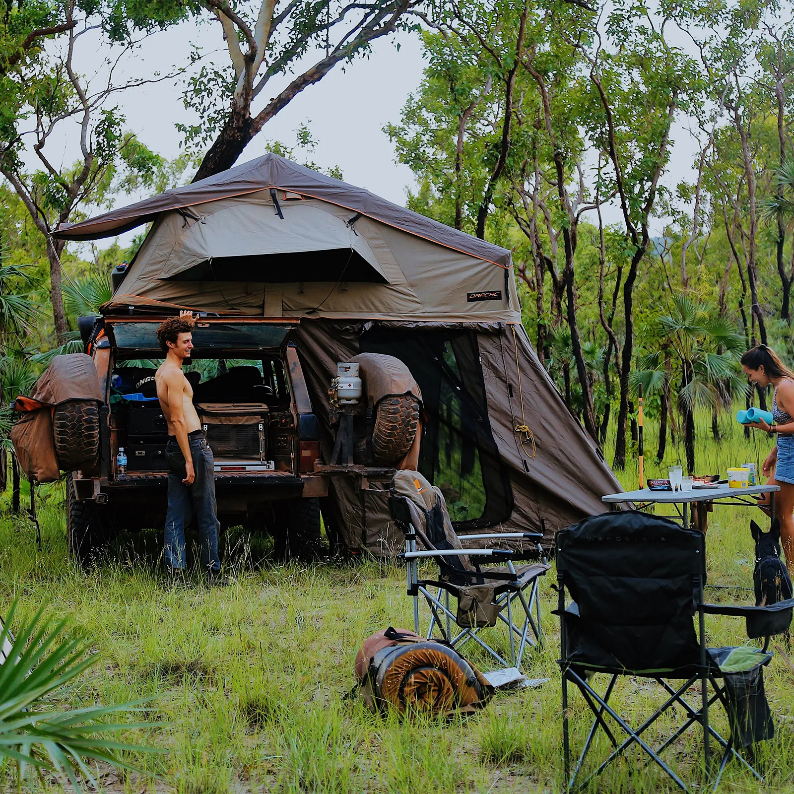 Camping scene with a vehicle equipped with a rooftop tent in a forest setting Range Rover Adventures | Range Rover Classic | Range Rover Restoration | Range Rove Build | Overlanding Range Rover Classic | Touring Range Rover Classsic
