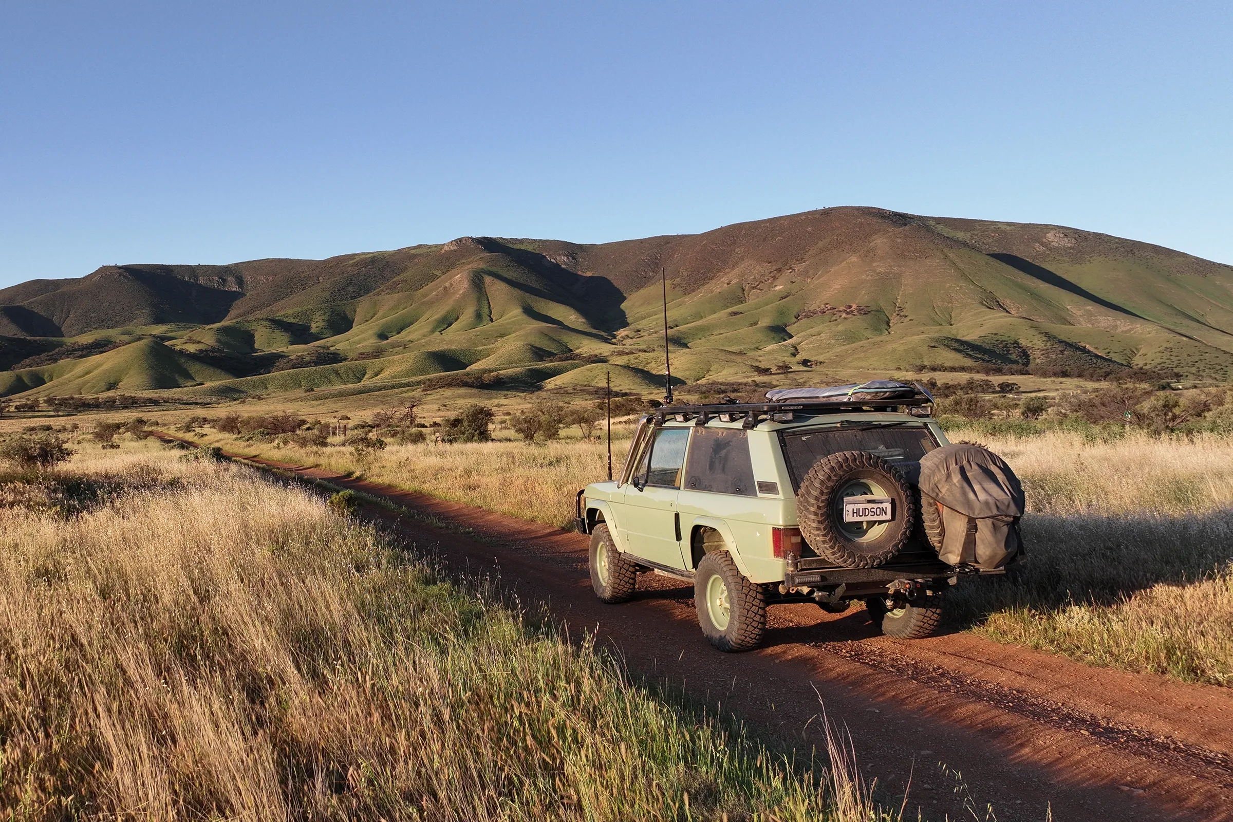 Range Rover Classic Driving along dirt road towards ranges | Expedition series Range Rover Classic | Hudson Coachworks Range Rover | Range Rover Restorations | Offroad Range Rover