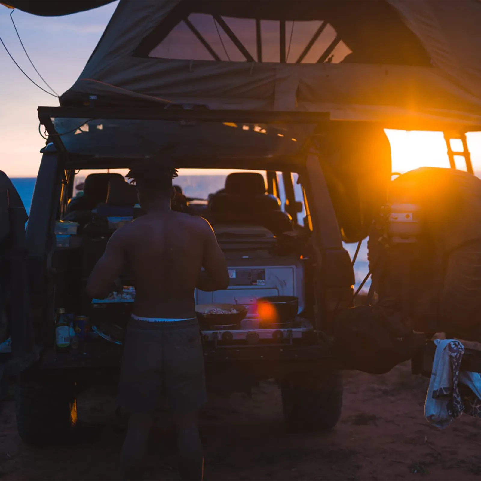Cooking on the back of a Range Rover Classic with Rofftop tent at camp as the sun sets | Range Rover Adventures | Range Rover Classic | Range Rover Restoration | Range Rove Build | Overlanding Range Rover Classic | Touring Range Rover Classsic
