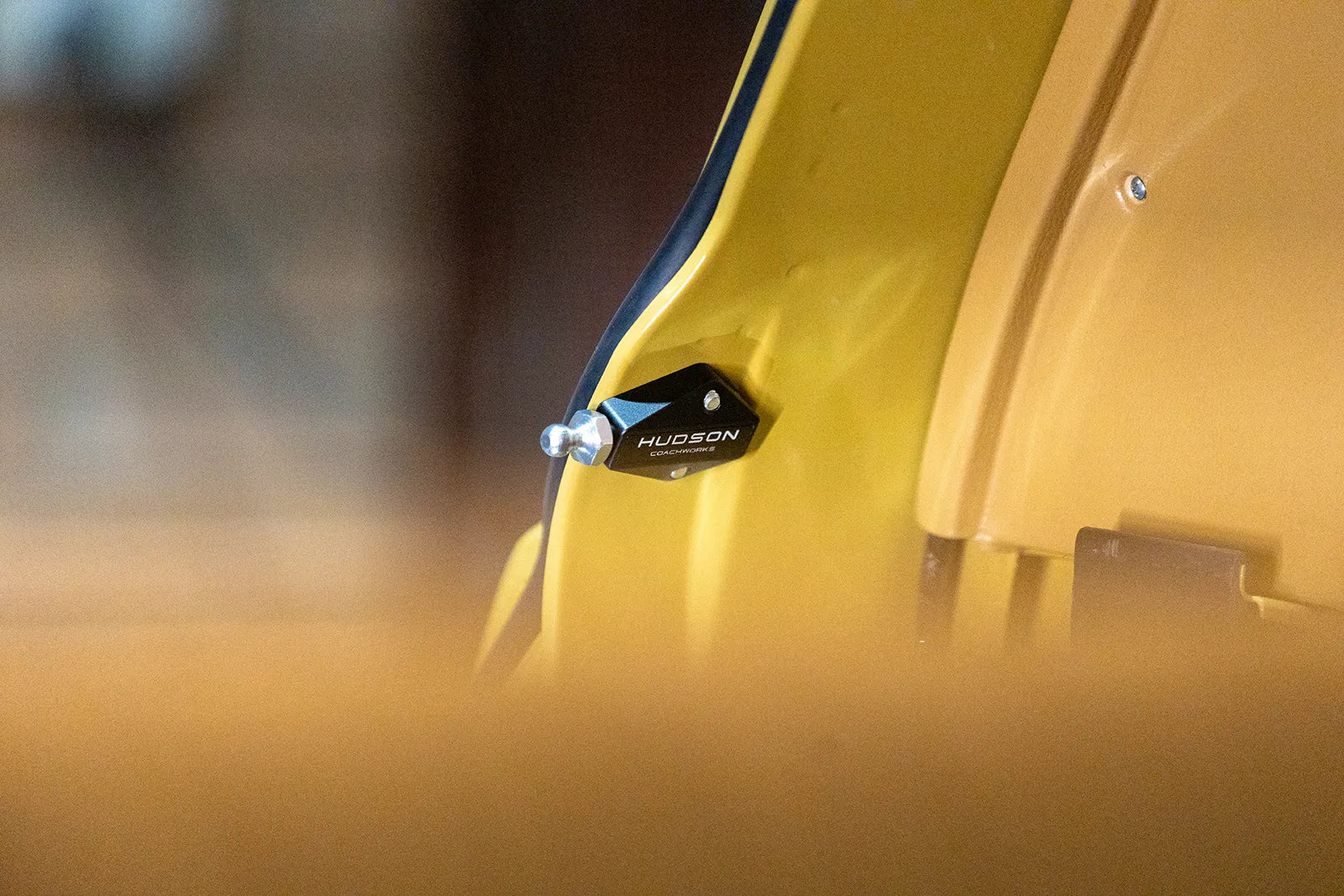 Hudson Coachworks Range Rover Classic Billet Upper Tailgate Strut Relocation Block on yellow range rover | Hudson Coachworks | Range Rover Classic Parts | Range Rover Classic Accessories | Aftermarket Range Rover Parts | Range Rover Classic Engineering