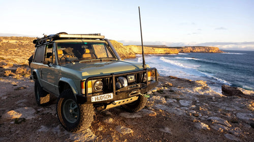 A Hudson Coachworks Expedition Series Range Rover Classic sits along a rugged coastline at golden hour | Hudson Coachworks Expedition Series | Range Rover Classic | Touring Range Rover | Overlanding Range Rover | Expedition Range Rover